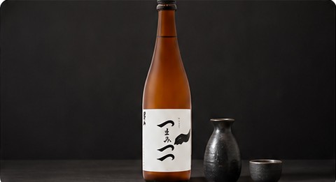 Bottle of Otokoyama sake with a carafe and cup